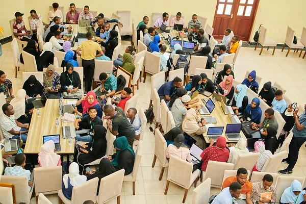 Attendees spread across tables during a conference work session